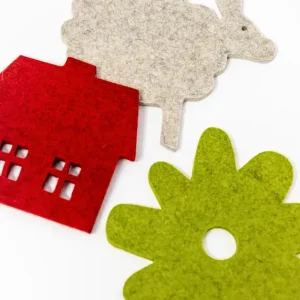 Several wool felt trivets in different shapes and colours