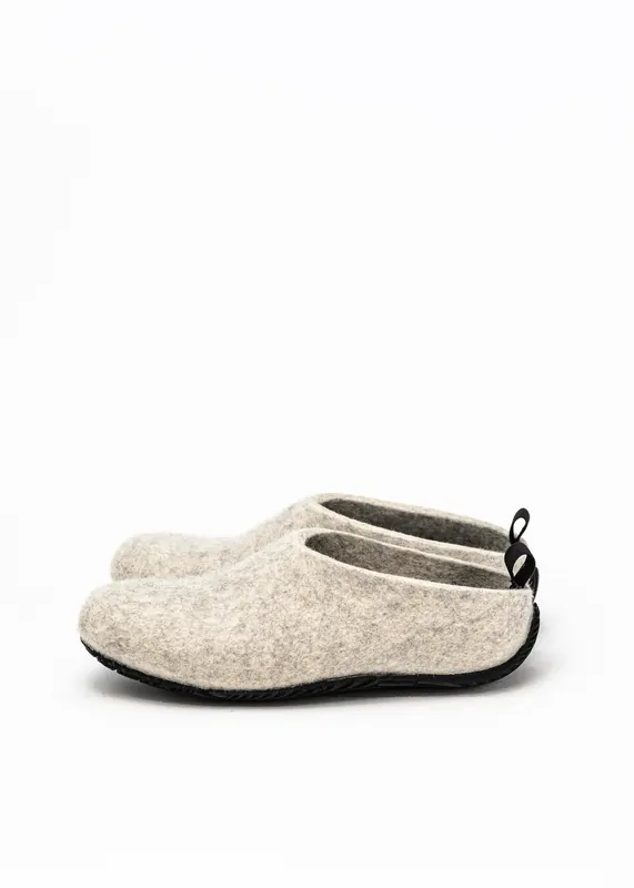 Grey wool-felt shoes photographed from the left side, showing the textured black sole and pull loop.